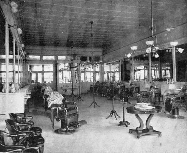 The interior of Alonzo Herndon's Crystal Palace barbershop in 1903: marble, mirrors, chandeliers and rows of chairs.