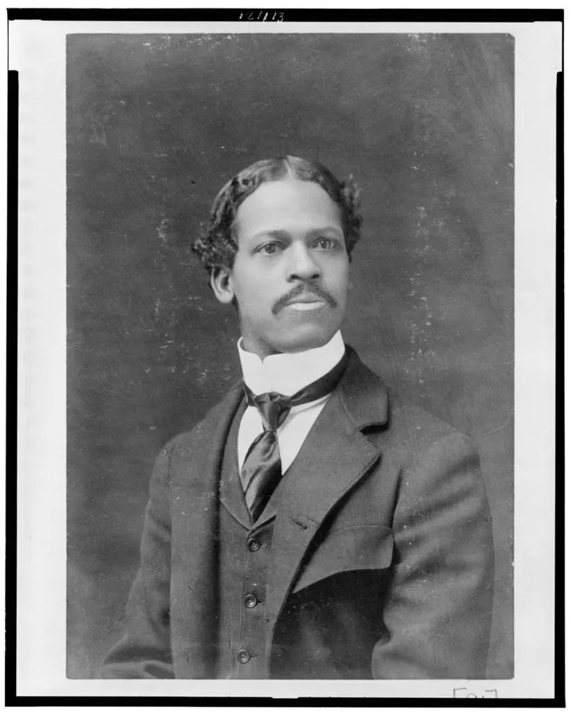 Studio portrait of a young Black man in a high collar and tie, from the albums Du Bois took to the 1900 Paris Exposition.
