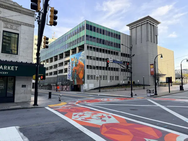 The intersection at Five Points with the MARTA station and a mural on the parking deck beyond.